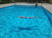 Woman Swimming in clean pool in Little Rock Arkansas by the best pool cleaners near me