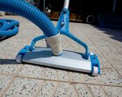 Picture of a pool Vacuum on the tile deck beside a swimming pool in Little Rock AR